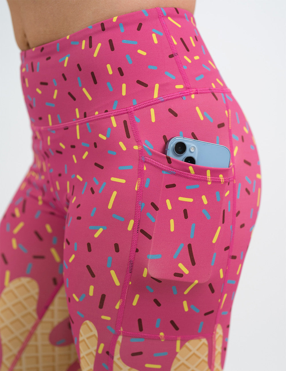 close up of the pink ice cream cone with sprinkles leggings with a phone in its pocket