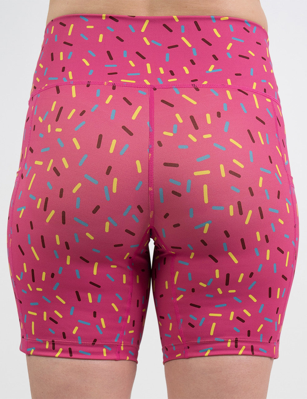 back of the 7 inch pink shorts with a sprinkles pattern against a white background