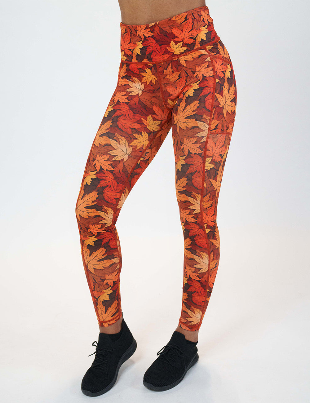 front of the orange leaves full length leggings against a white background