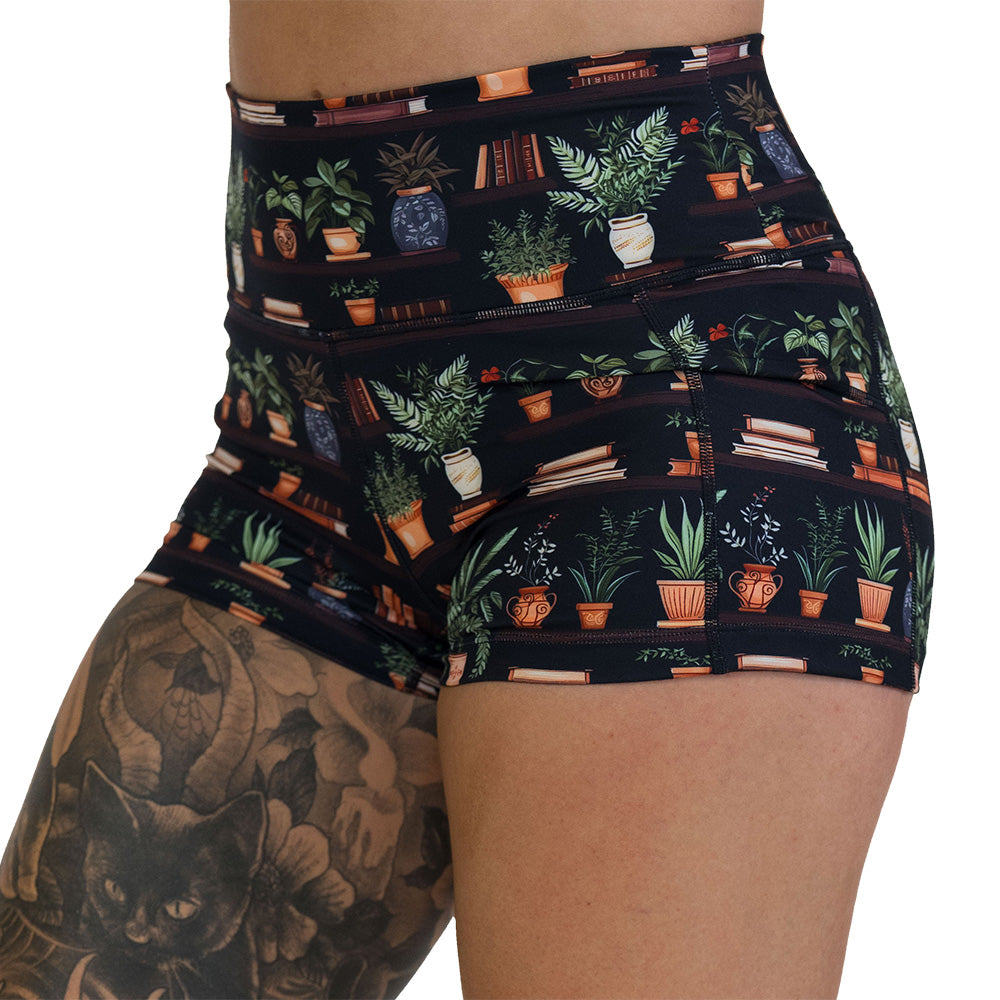 floral patterned shorts with books design on it
