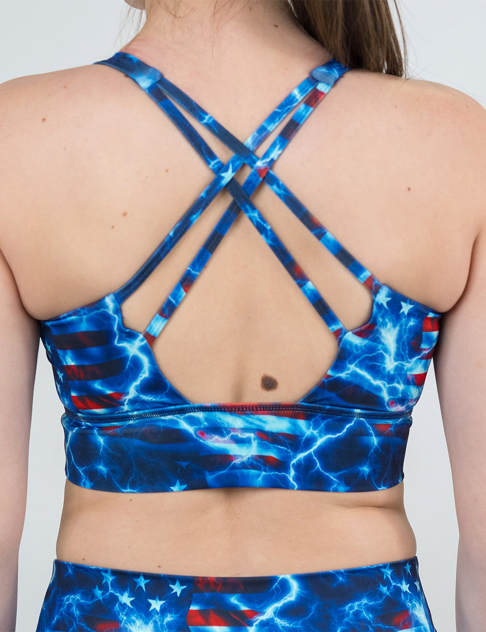 back of the lightning flag longline bra against a white background against a white background