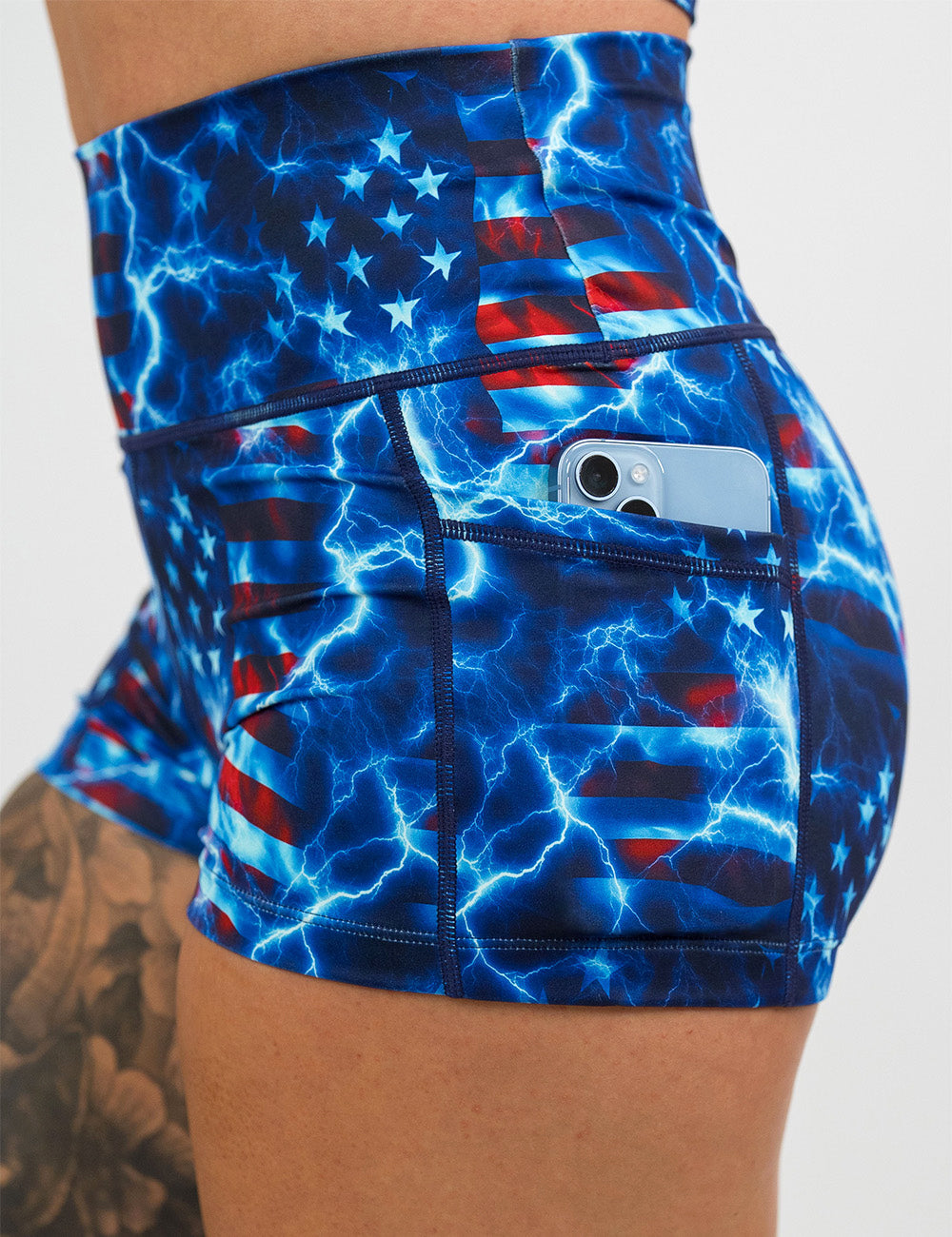 close up of the 2.5 inch lightning flag shorts with a phone in it's pocket against a white background