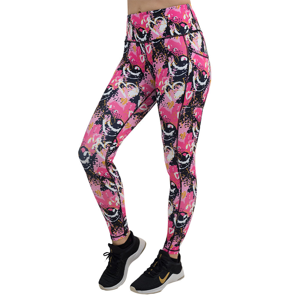 white hearts against a bold pink, black, and yellow pattern full length leggings facing the front against a white background