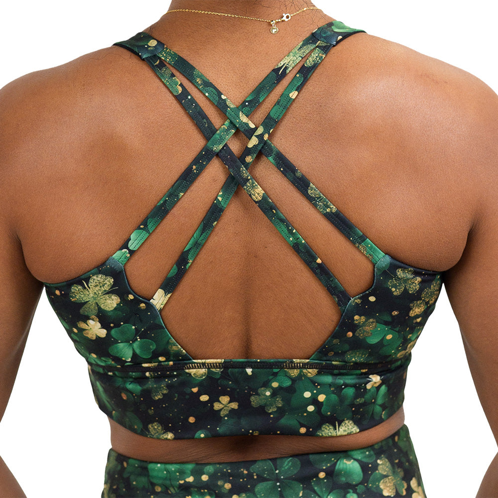 back of the green and gold shamrock patterned longline bra against a white background