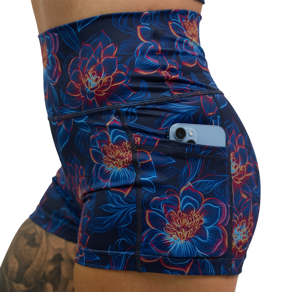 close up of the luminous lotus 2.5 inch shorts with a phone in the pocket