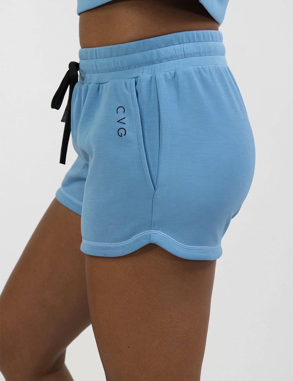 side view of the blue drawstring shorts against a white background