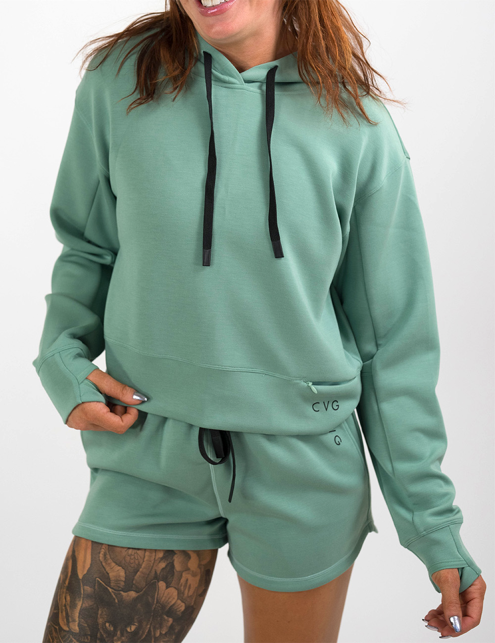 front of the light green hoodie with black drawstrings against a white background