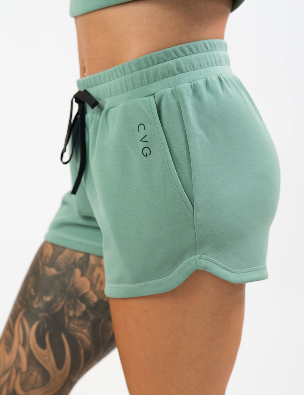 light green draw string shorts facing the side against a white background