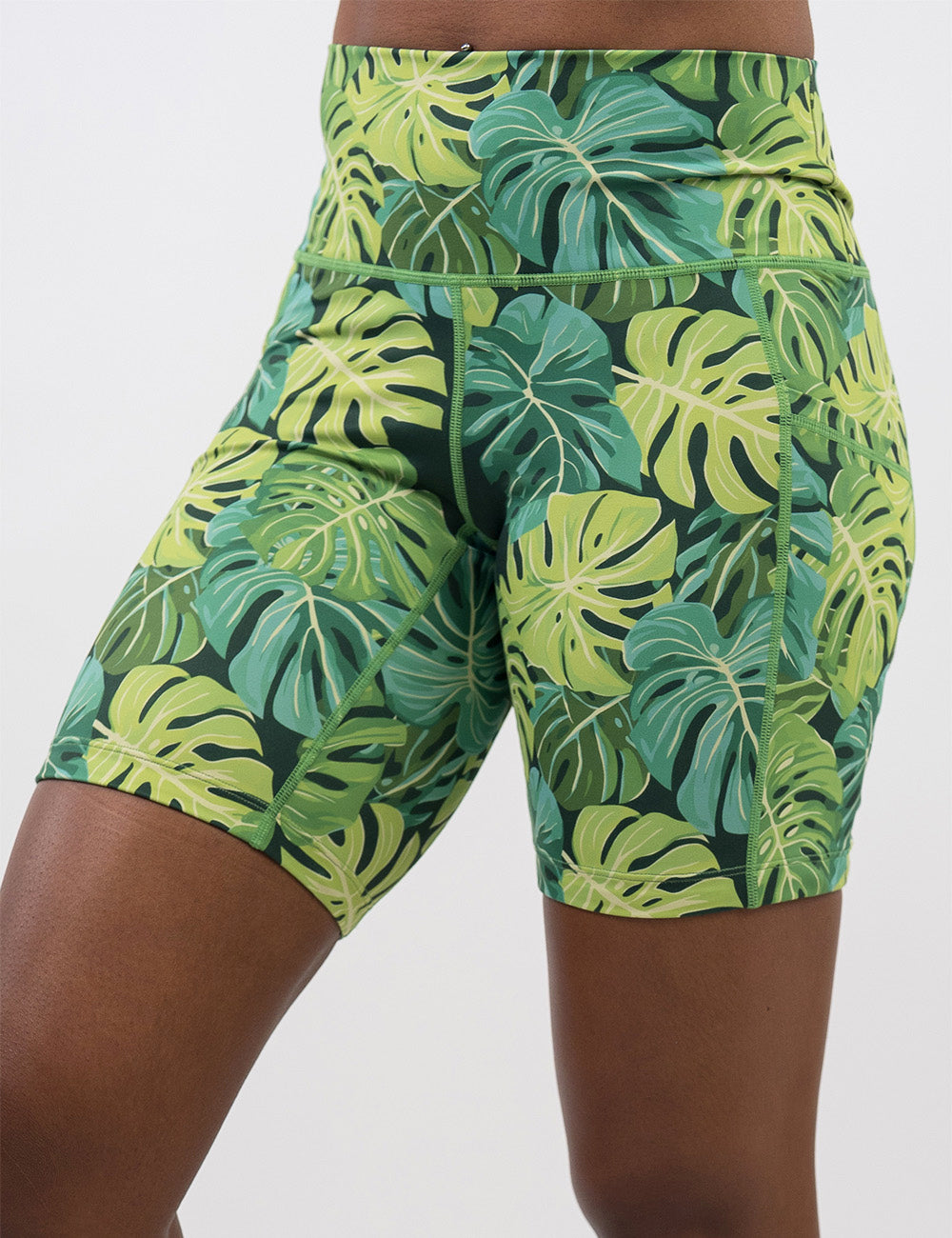 front of the 7 inch green tropical leaves shorts against a white background