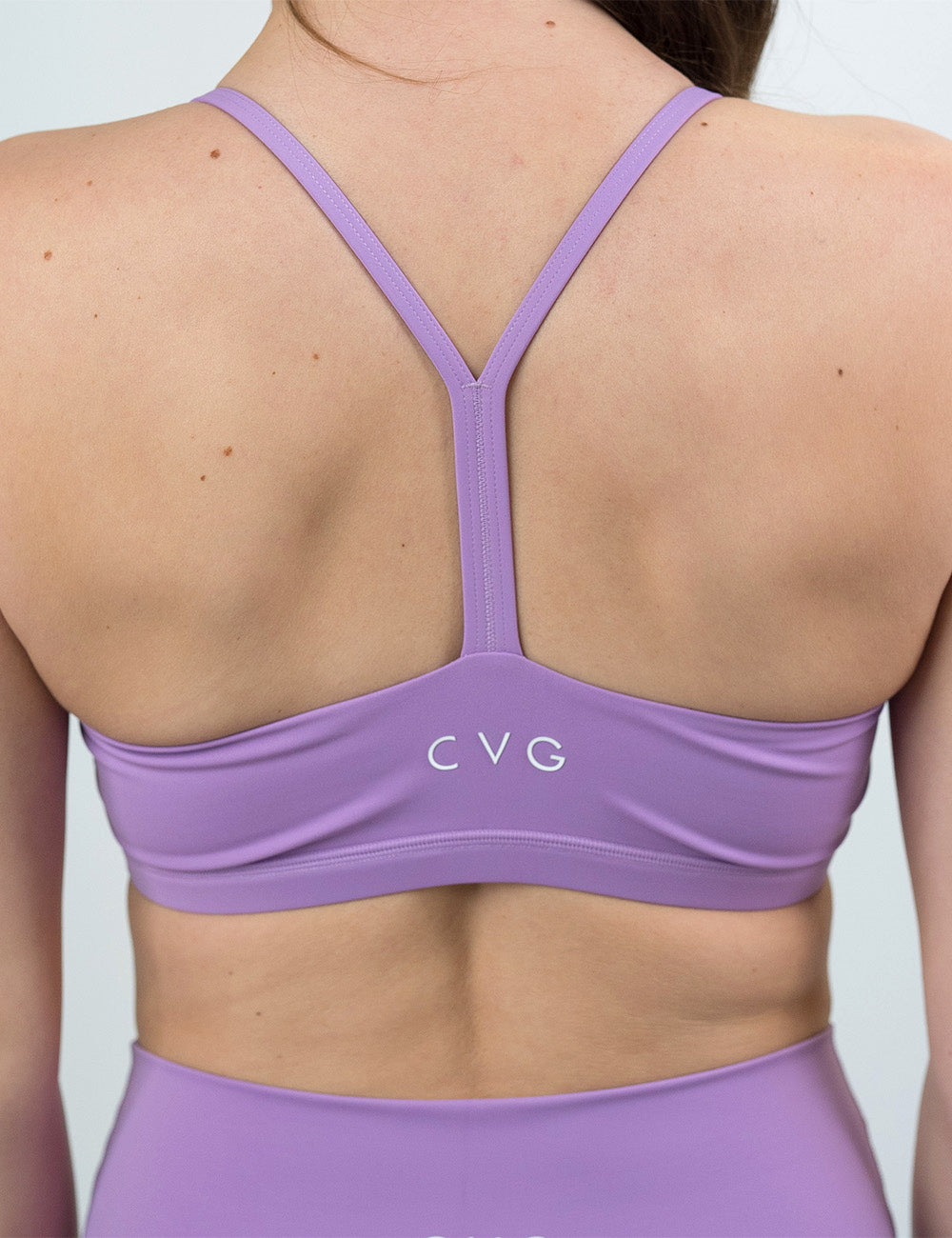 back of the solid purple move free bra against a white background