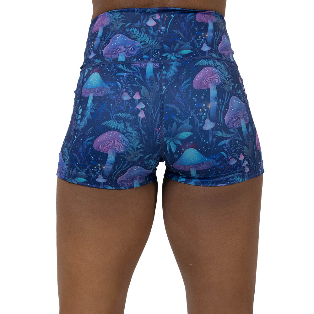 back of the shorts with a blue and purple mushroom and foliage design on a white background