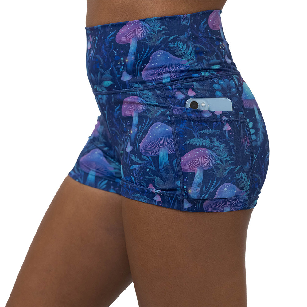 shorts with a blue and purple mushroom and foliage design on a white background