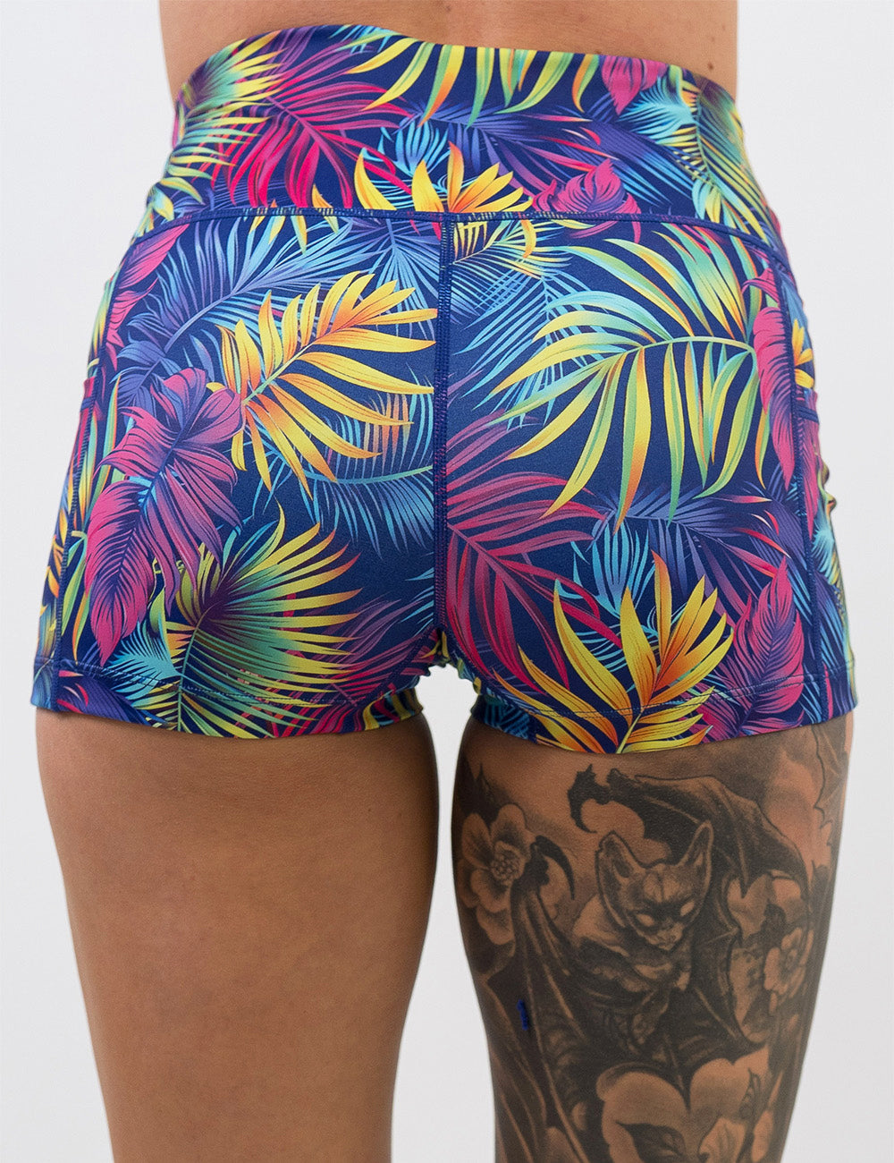 back of the 2.5 inch vibrant tropical leaves shorts against a white background