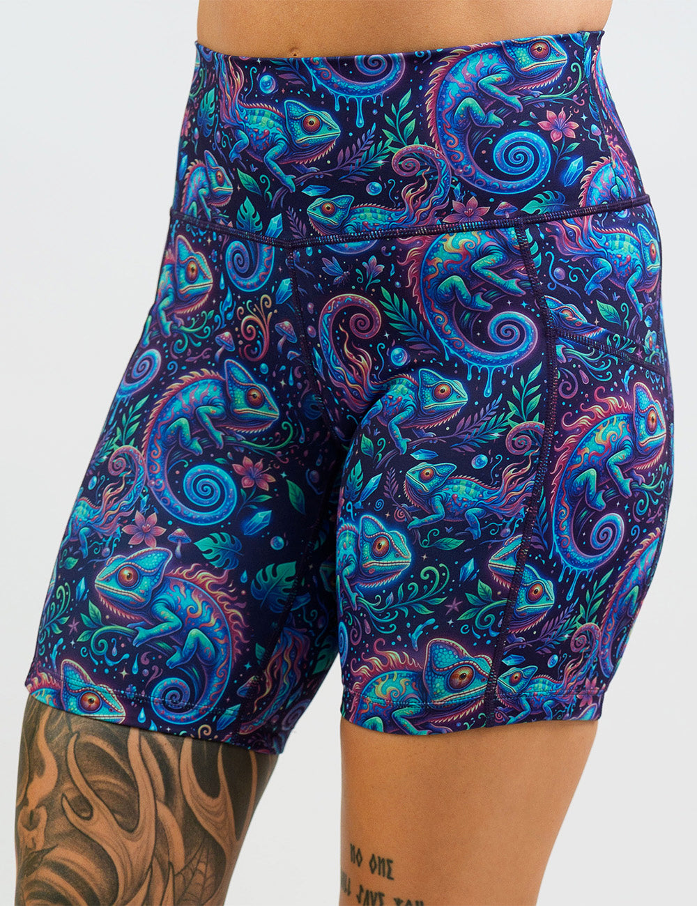 front of the orange, blue, and red chameleons surrounded by plants 7 inch shorts against a white background