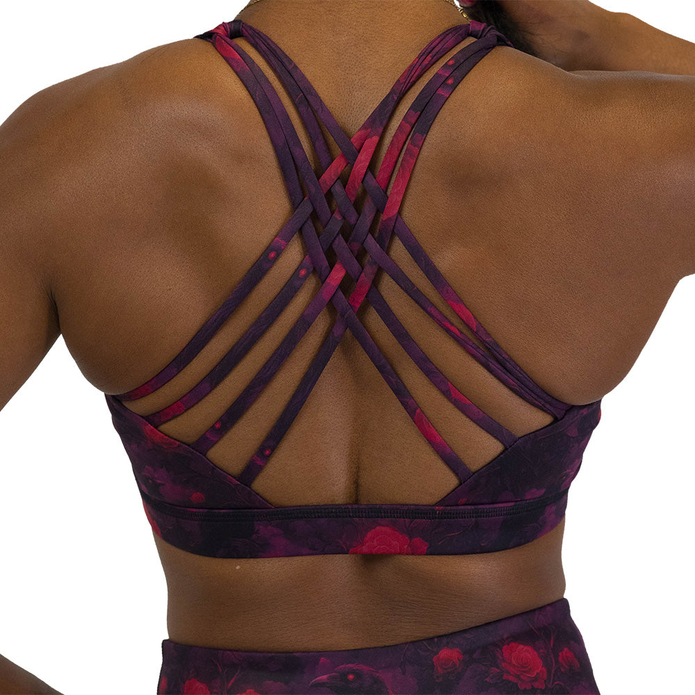 back of the Black sports bra with red floral and crow pattern on it