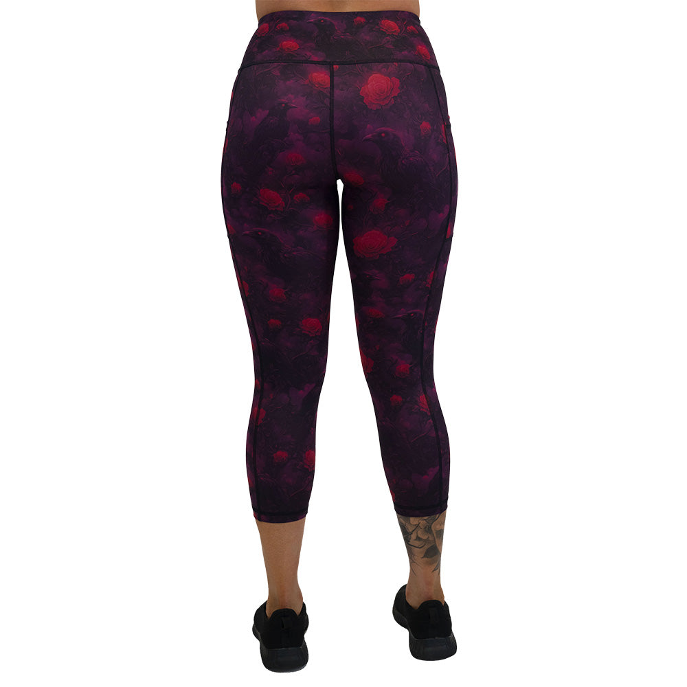 back of the Black leggings with red floral and crow pattern on it