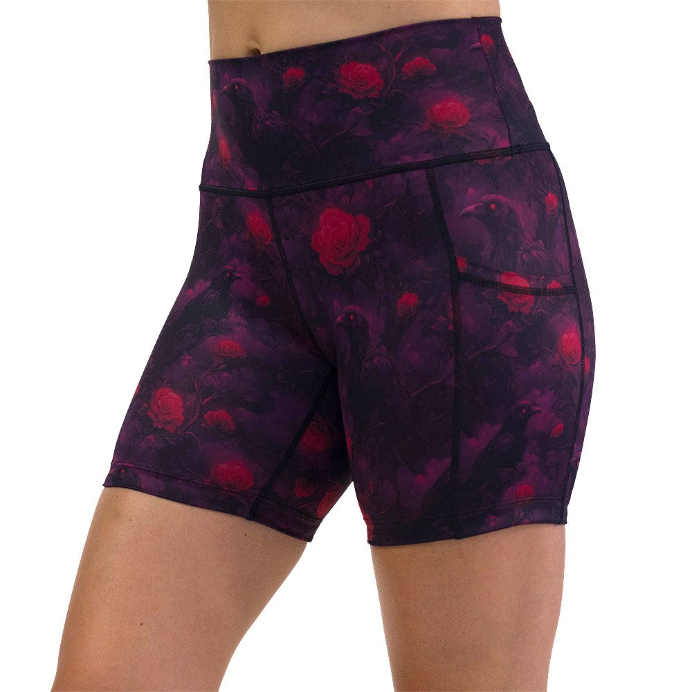 Black shorts with red floral and crow pattern on it