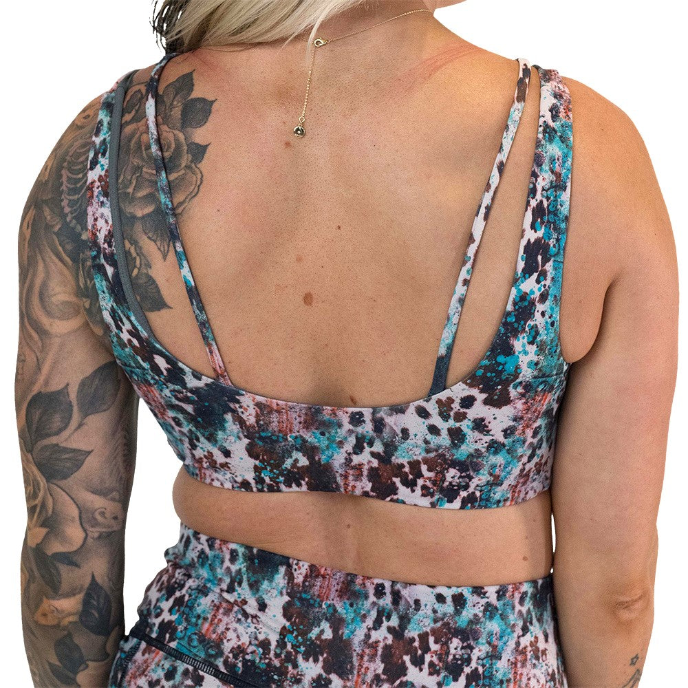 back of the leopard print with teal paint splatter sports bra