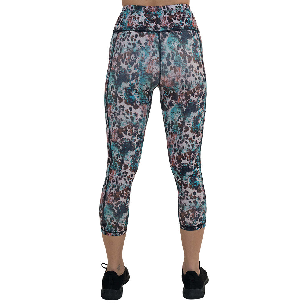 back of the capri length leopard print with teal paint splatter leggings