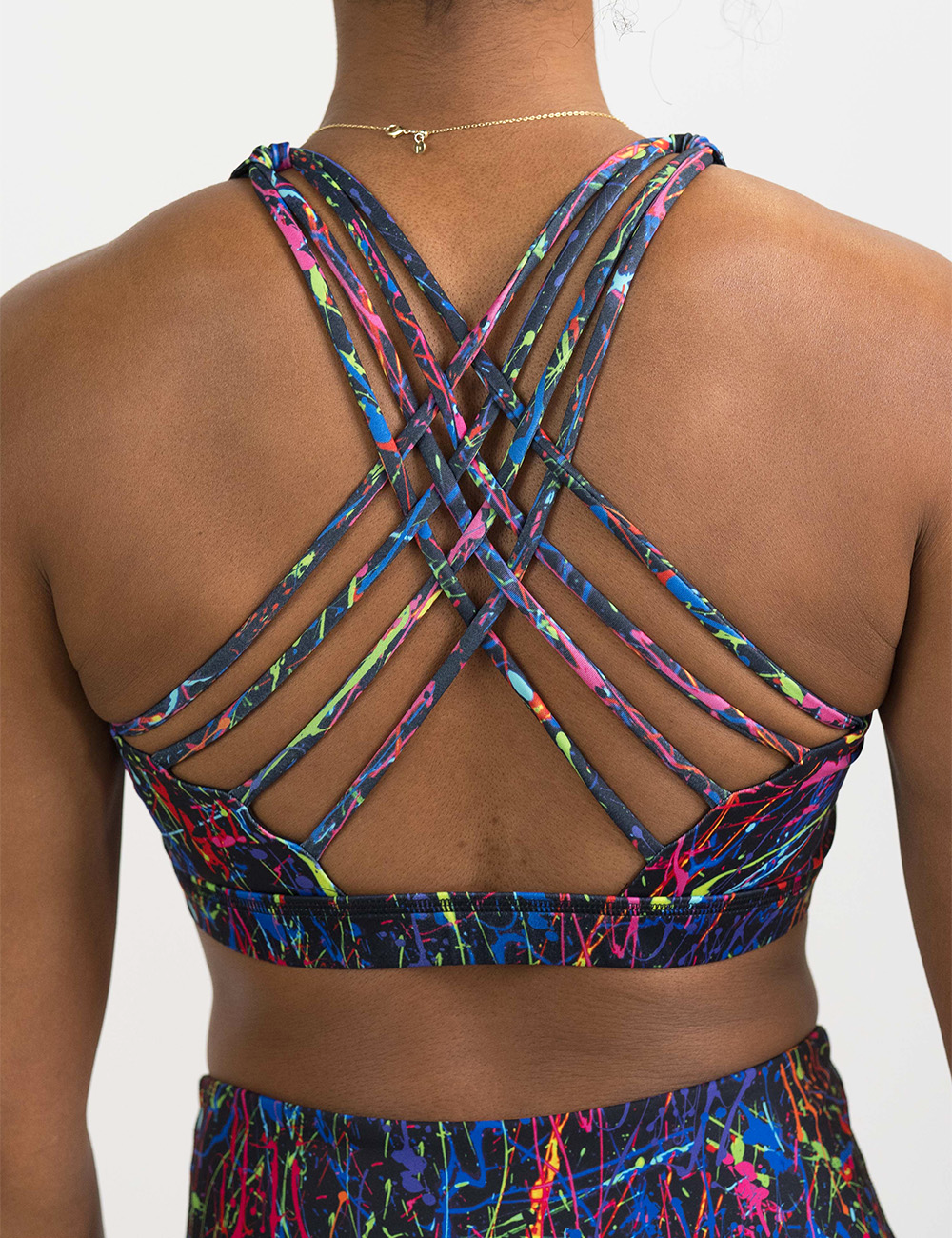 back of the rainbow paint splatter against a black background butterfly back bra