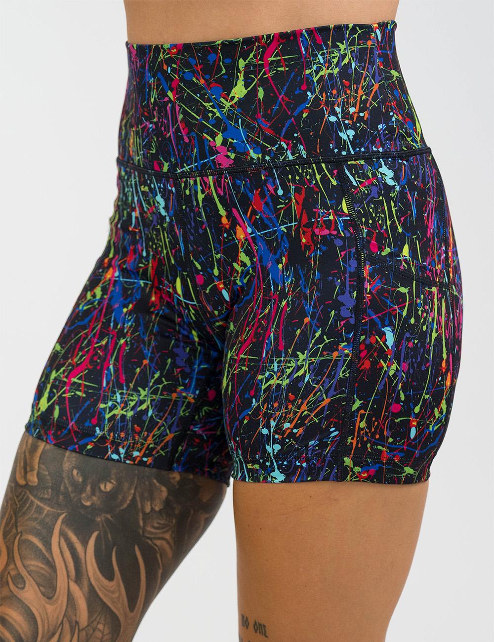 rainbow paint splatter against a black background 5 inch shorts facing the front against a white background
