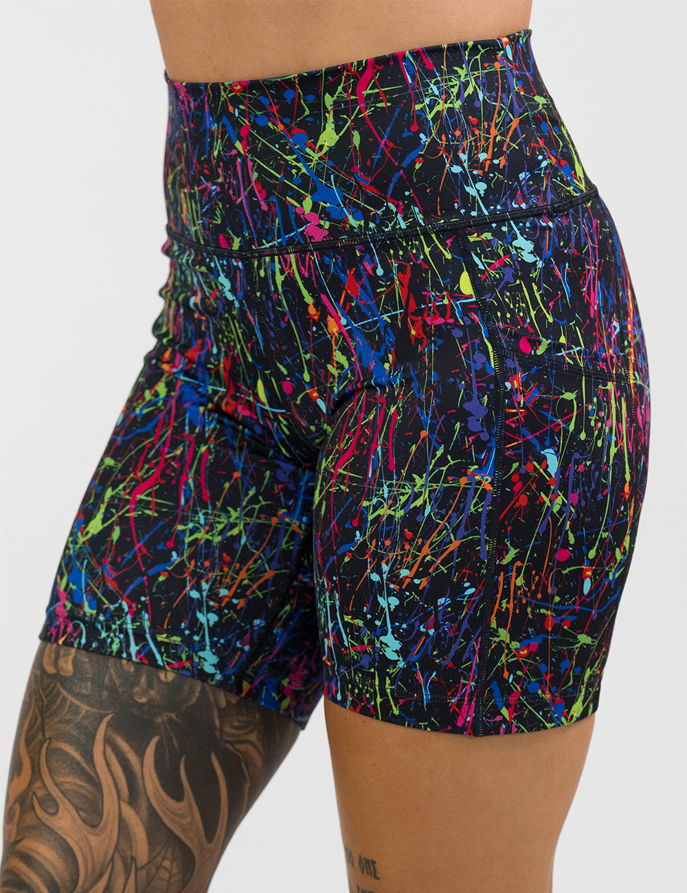 rainbow paint splatter against a black background 7 inch shorts facing the front against a white background