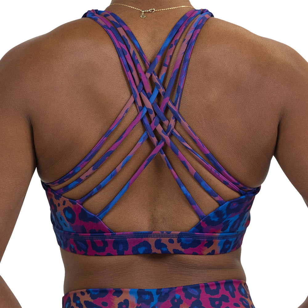 back of the cheetah print against a yellow, blue, and purple background pattern bra against a white background