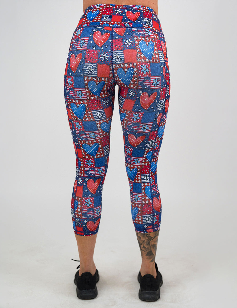 back of the capri red white and blue with hearts and flowers patchwork pattern leggings against a white background