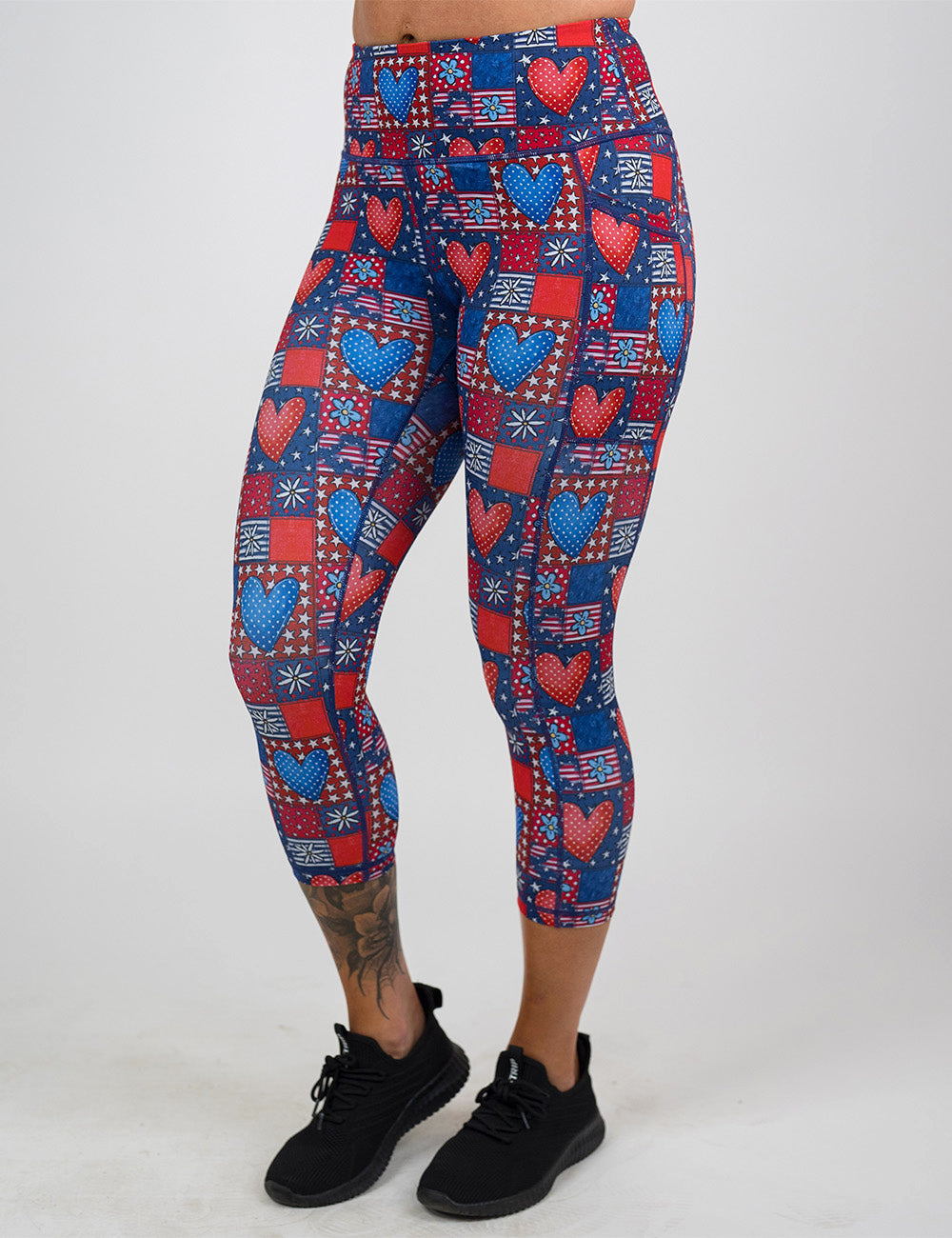 front of the capri red white and blue with hearts and flowers patchwork pattern leggings against a white background