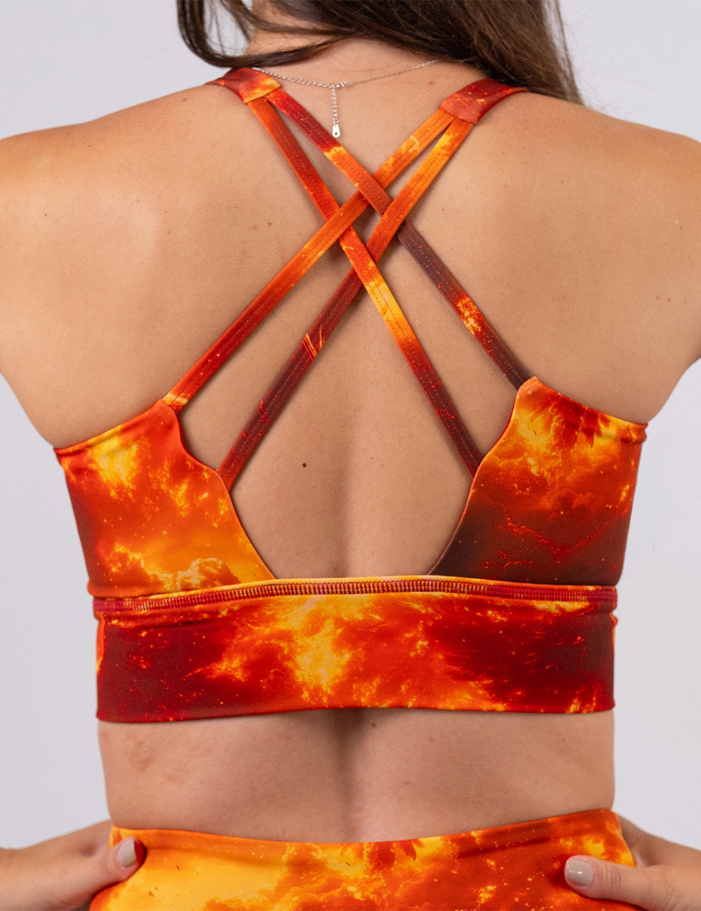 back of the phoenix surrounded by fire sports bra against a white background