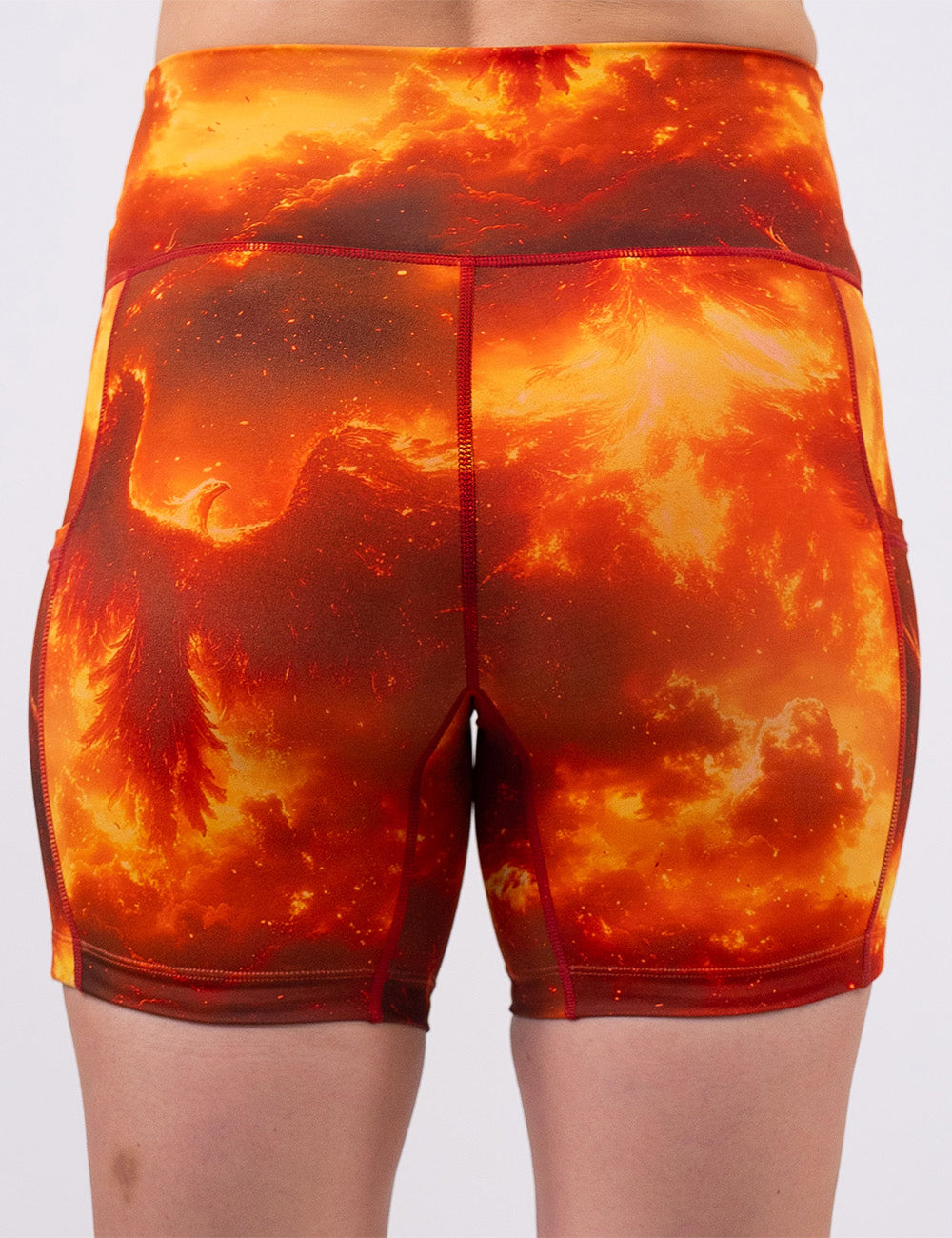 back of the 7 inch phoenix surrounded by fire shorts against a white background