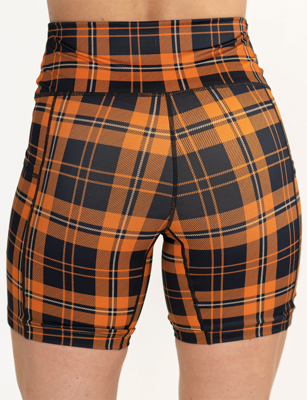 back of the 7 inch black and orange plaid shorts against a white background