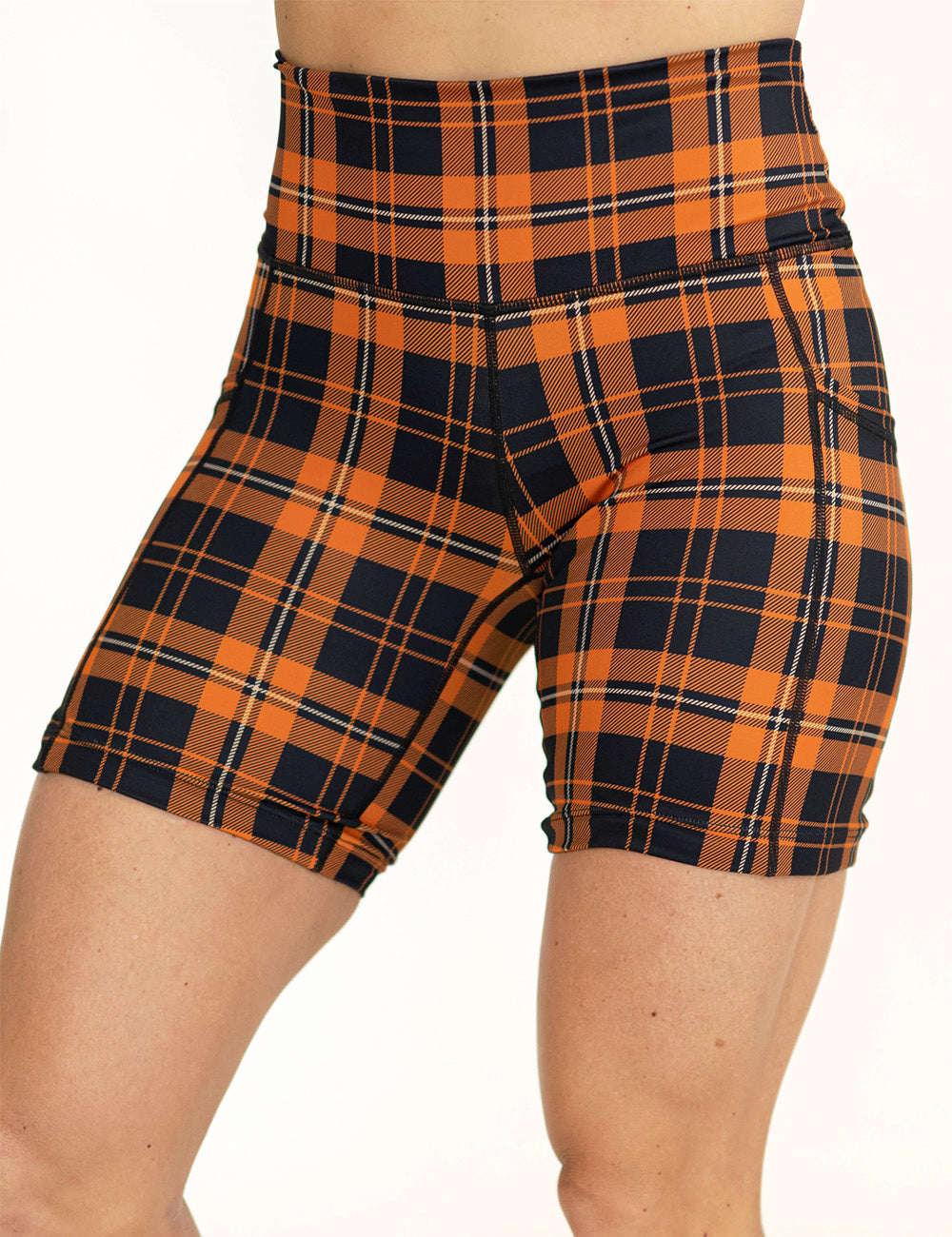 front of the 7 inch black and orange plaid shorts against a white background