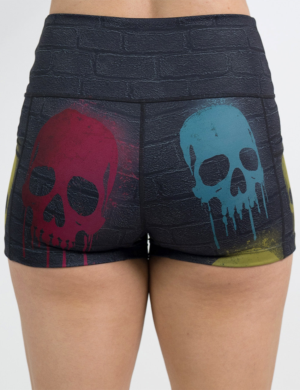 back of the 2.5 inch black brick pattern with blue, red, and yellow skull spray paint patterns shorts against a white background