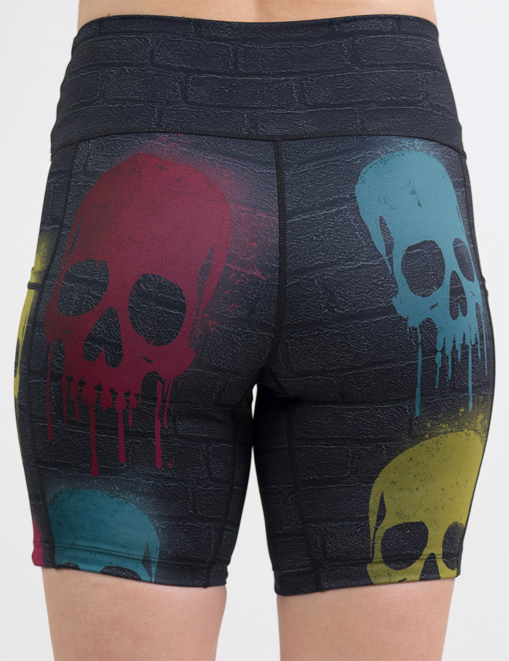 back of the black brick pattern with blue, red, and yellow skull spray paint patterns 7 inch shorts against a white background