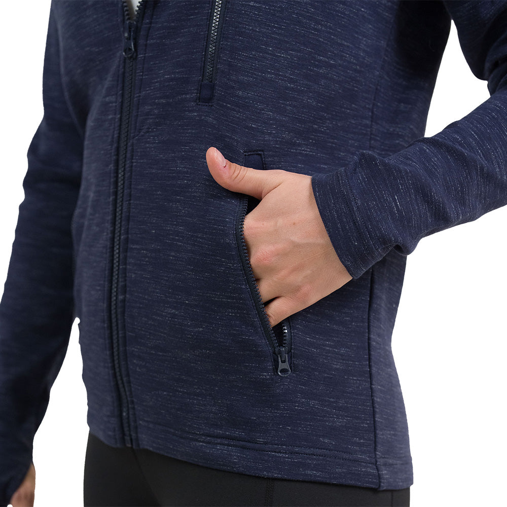 close up of the navy blue rest day zip up sweatshirt with a hand in the pocket against a white background