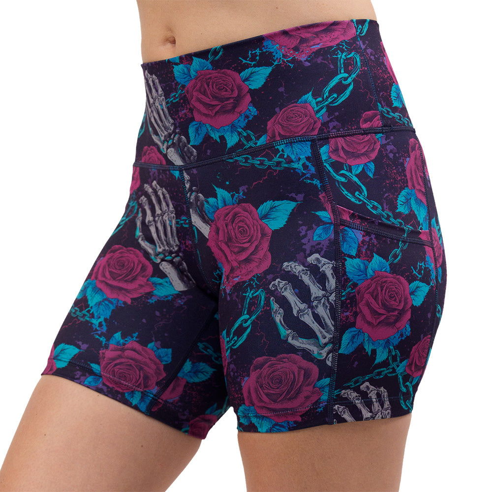 roses and skeleton hands connected by chain links pattern 5 inch shorts facing the front against a white background