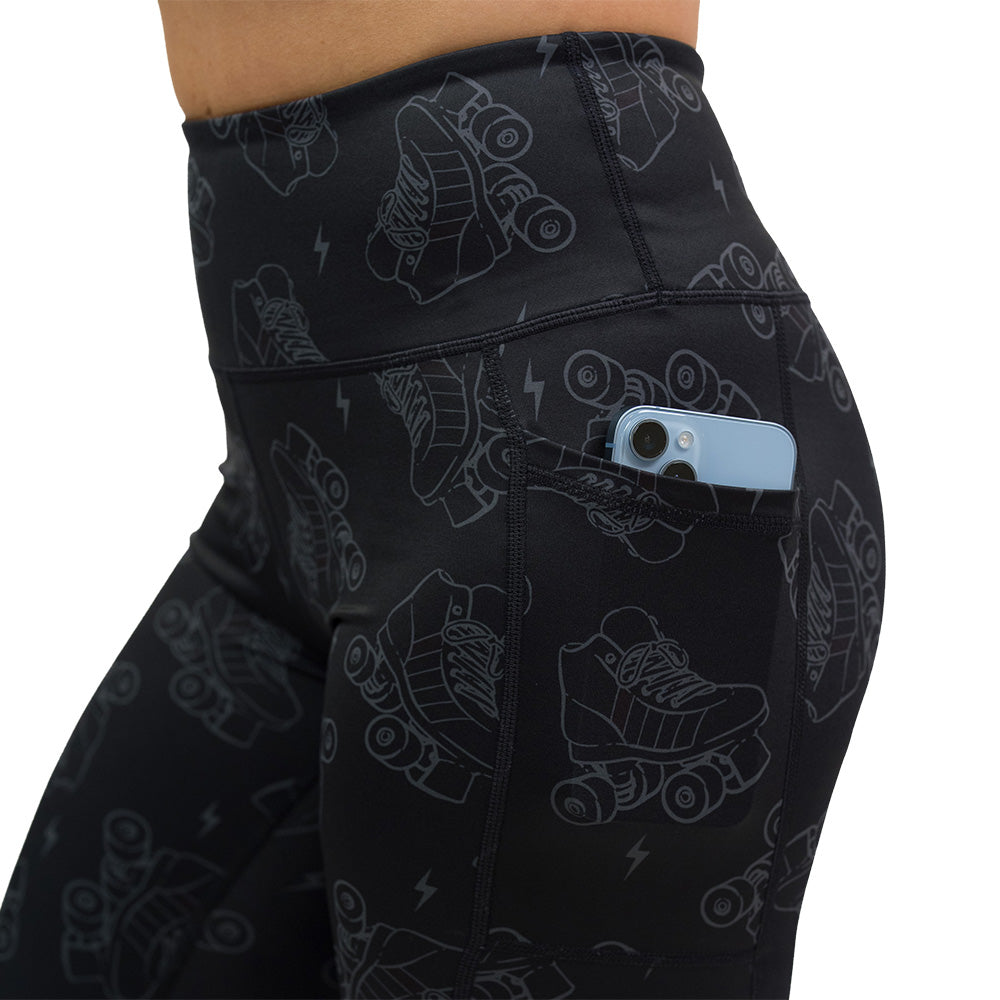 close up of dark roller skates and lighting print leggings with phone in pocket