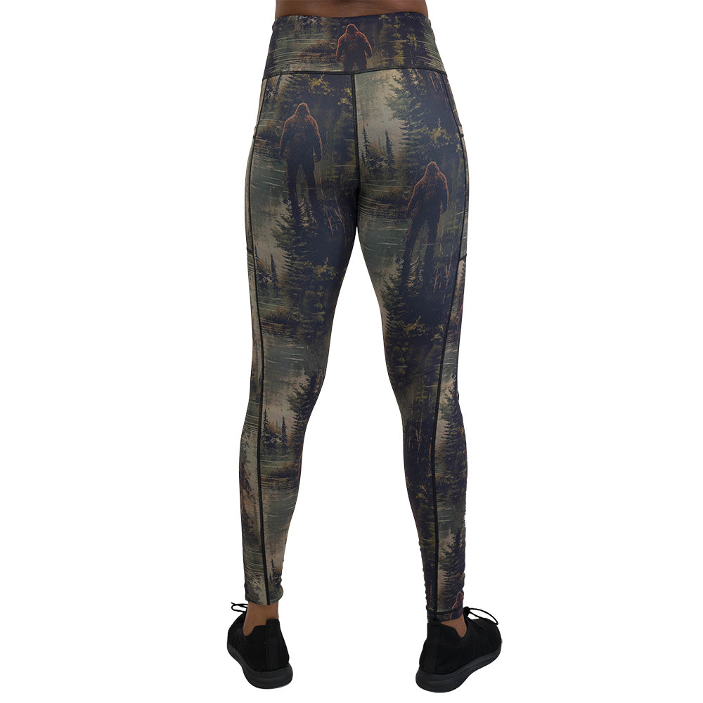 back of the leggings with a forest design and a bigfoot graphic on it