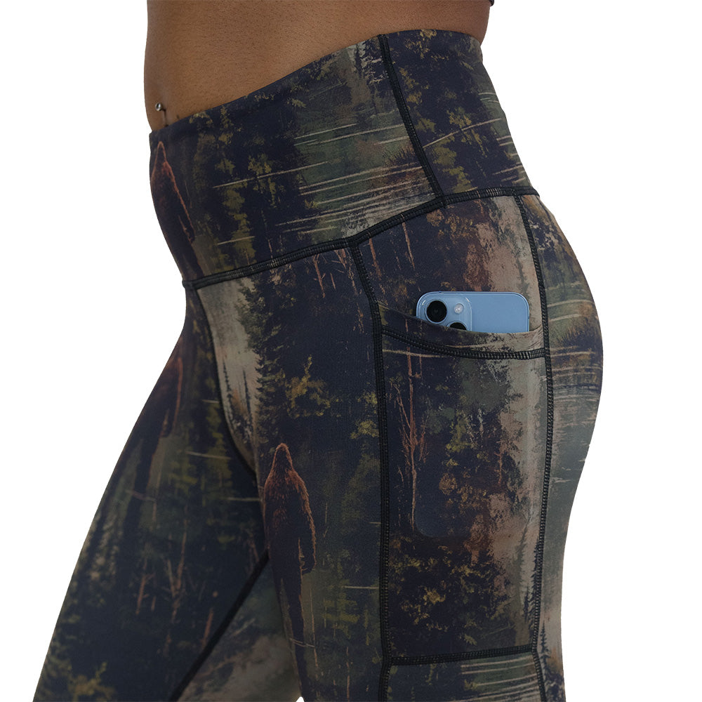 side pocket on the leggings with a forest design and a bigfoot graphic on it