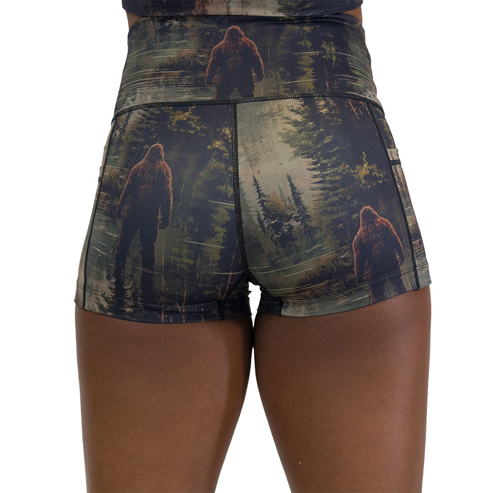 back of the shorts with a forest design and a bigfoot graphic on it