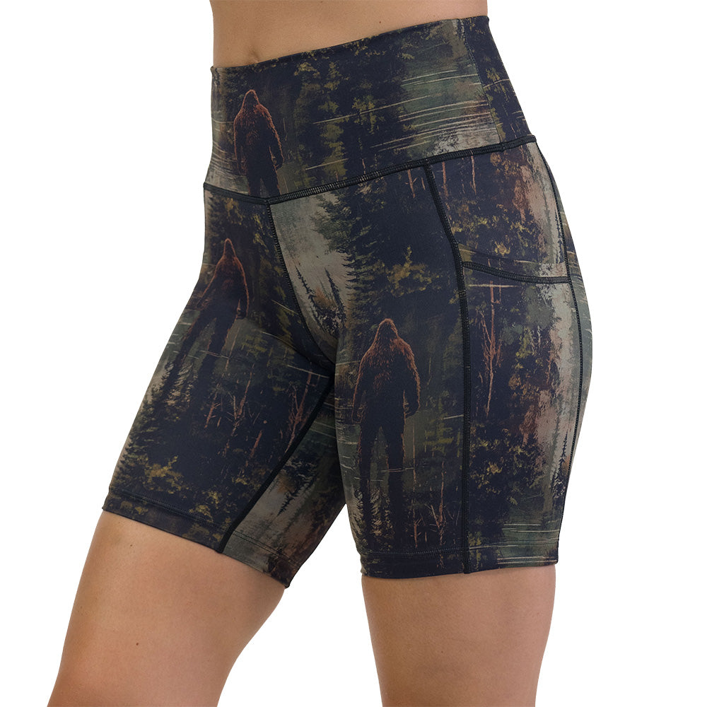shorts with a forest design and a bigfoot graphic on it