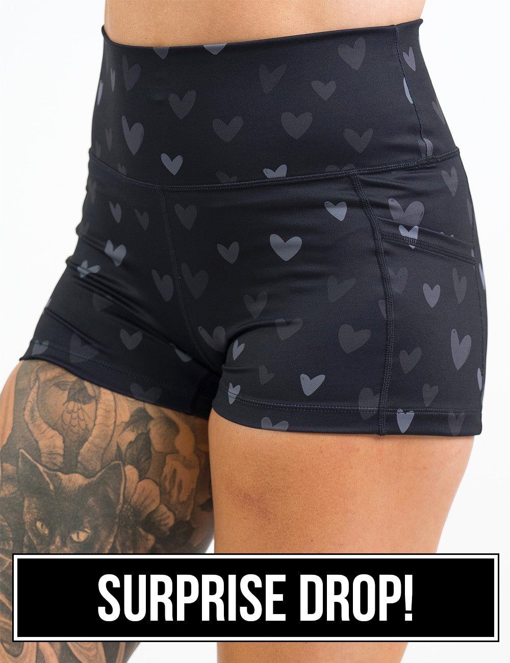 front of the 2.5 inch black shorts with light and dark grey hearts against a white background, surprise drop