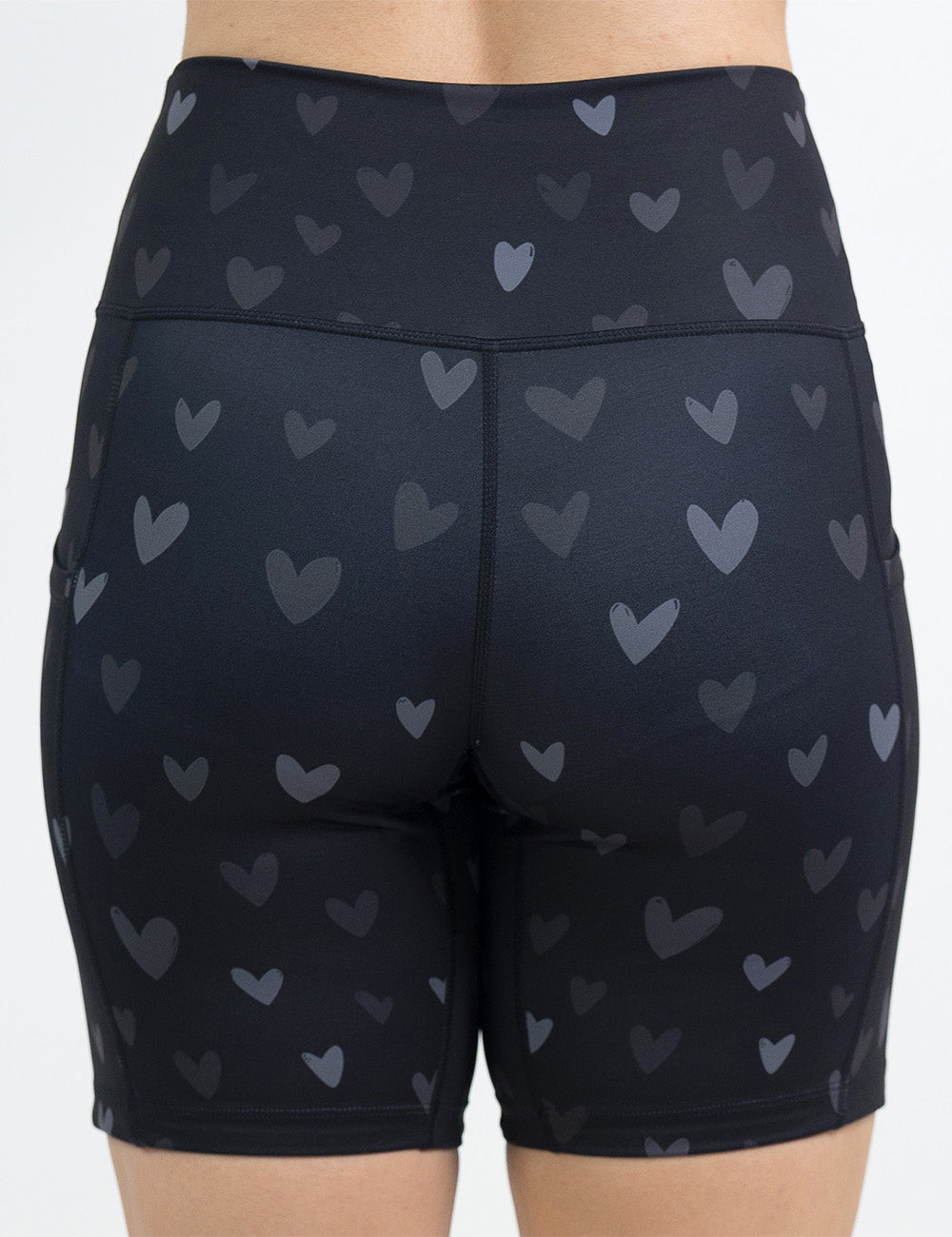 back of the 7 inch black shorts with light and dark grey hearts against a white background