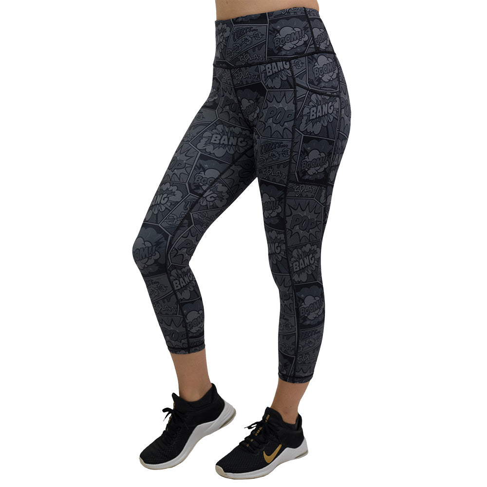 black and grey comic book print capri leggings with knee raised facing the front