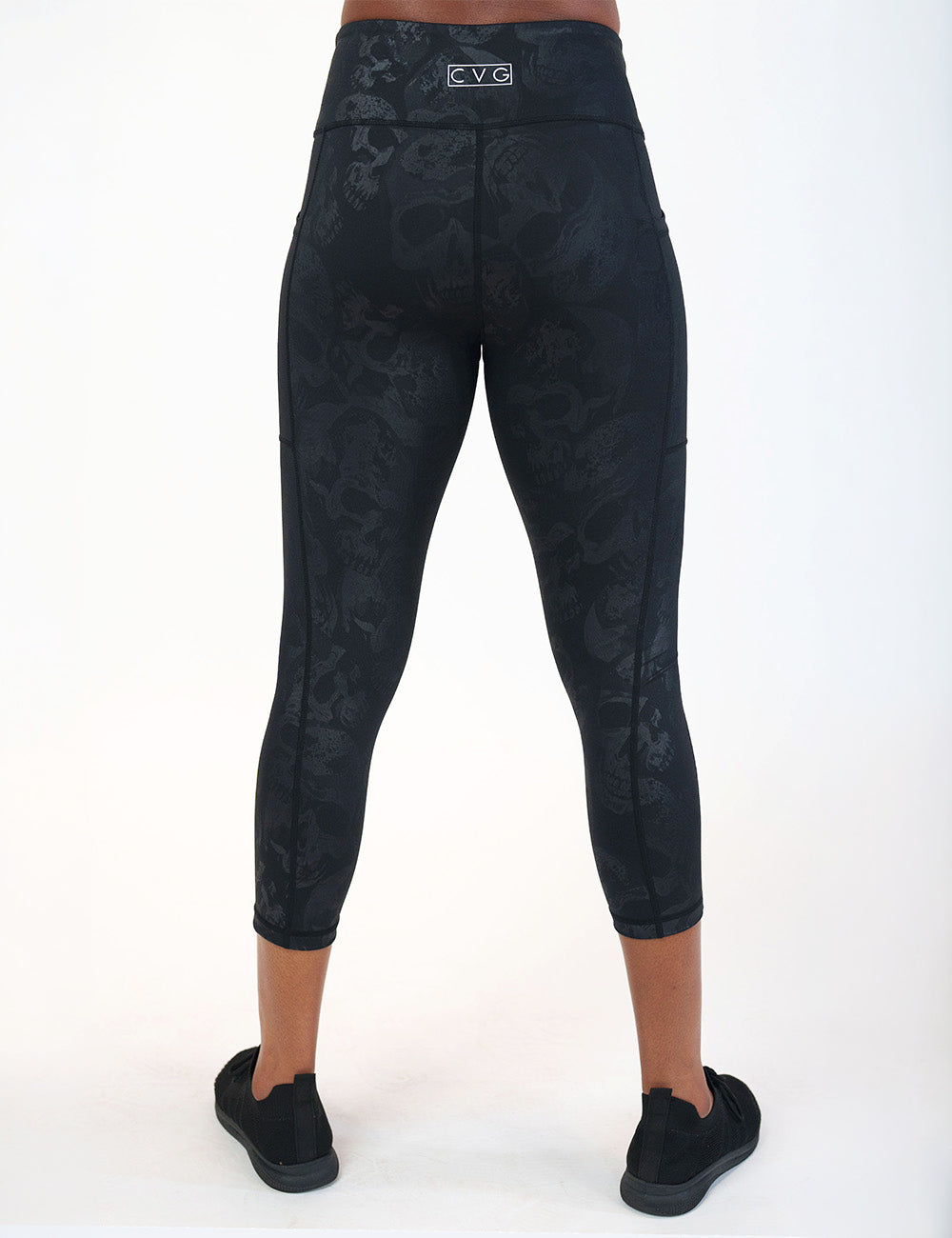 back of the capri black leggings with a dark grey skull pattern against a white background
