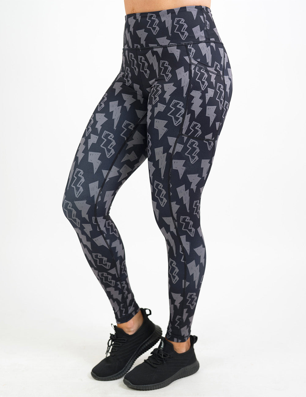 front of the full length black leggings with grey thunderbolts against a white background