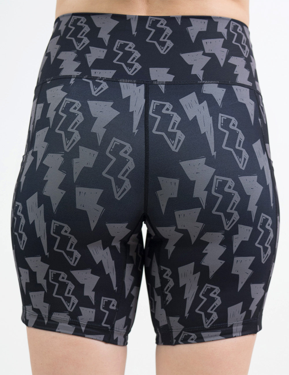back of the 7 inch black shorts with grey lightning bolts against a white background