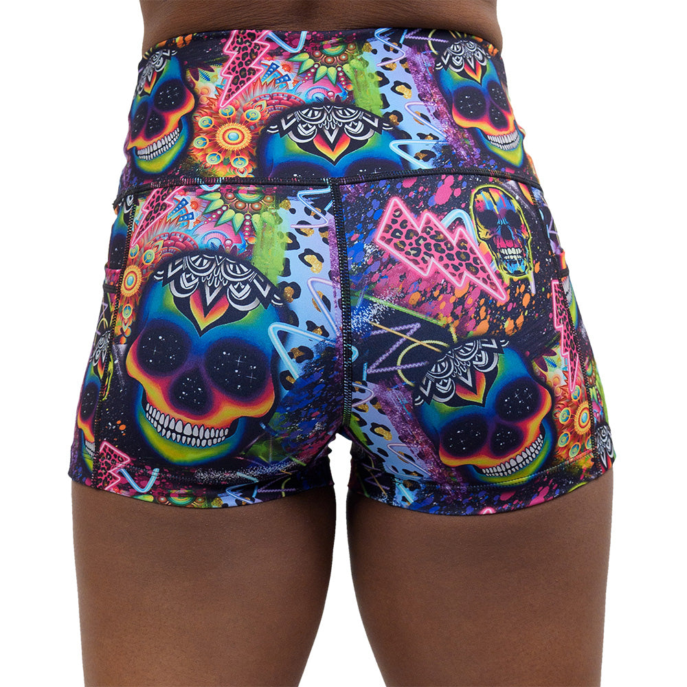back of the the brightly colored psychedelic skulls pattern against a busy background full of designs 2.5 inch shorts against a white background