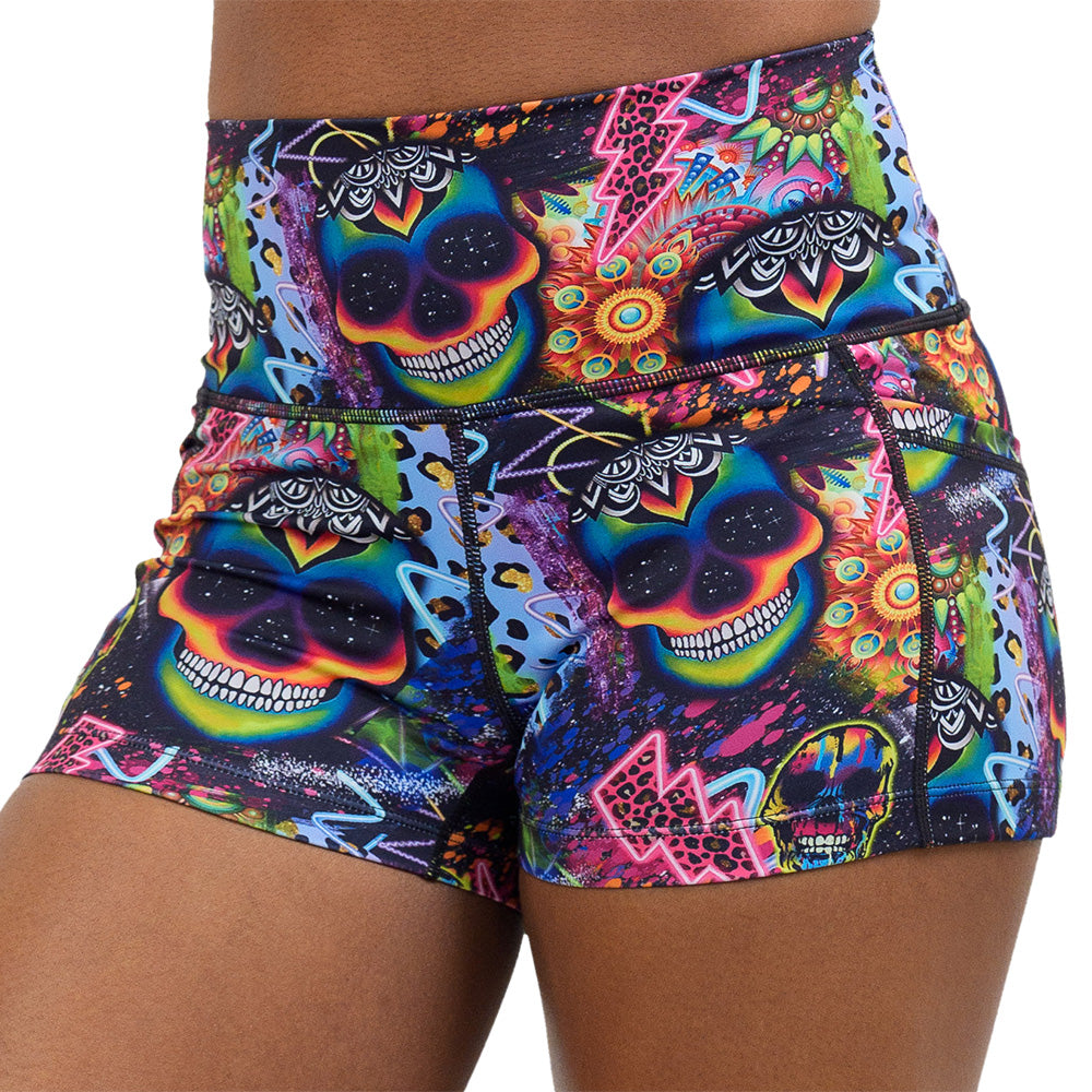 close up of the brightly colored psychedelic skulls pattern against a busy background full of designs 2.5 inch shorts against a white background